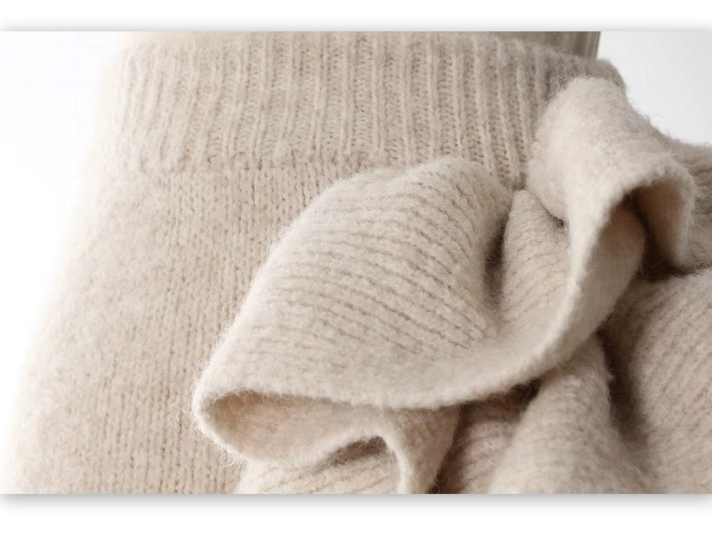 Cozy knitwear ensemble featuring a sleeveless turtleneck and flower applique skirt