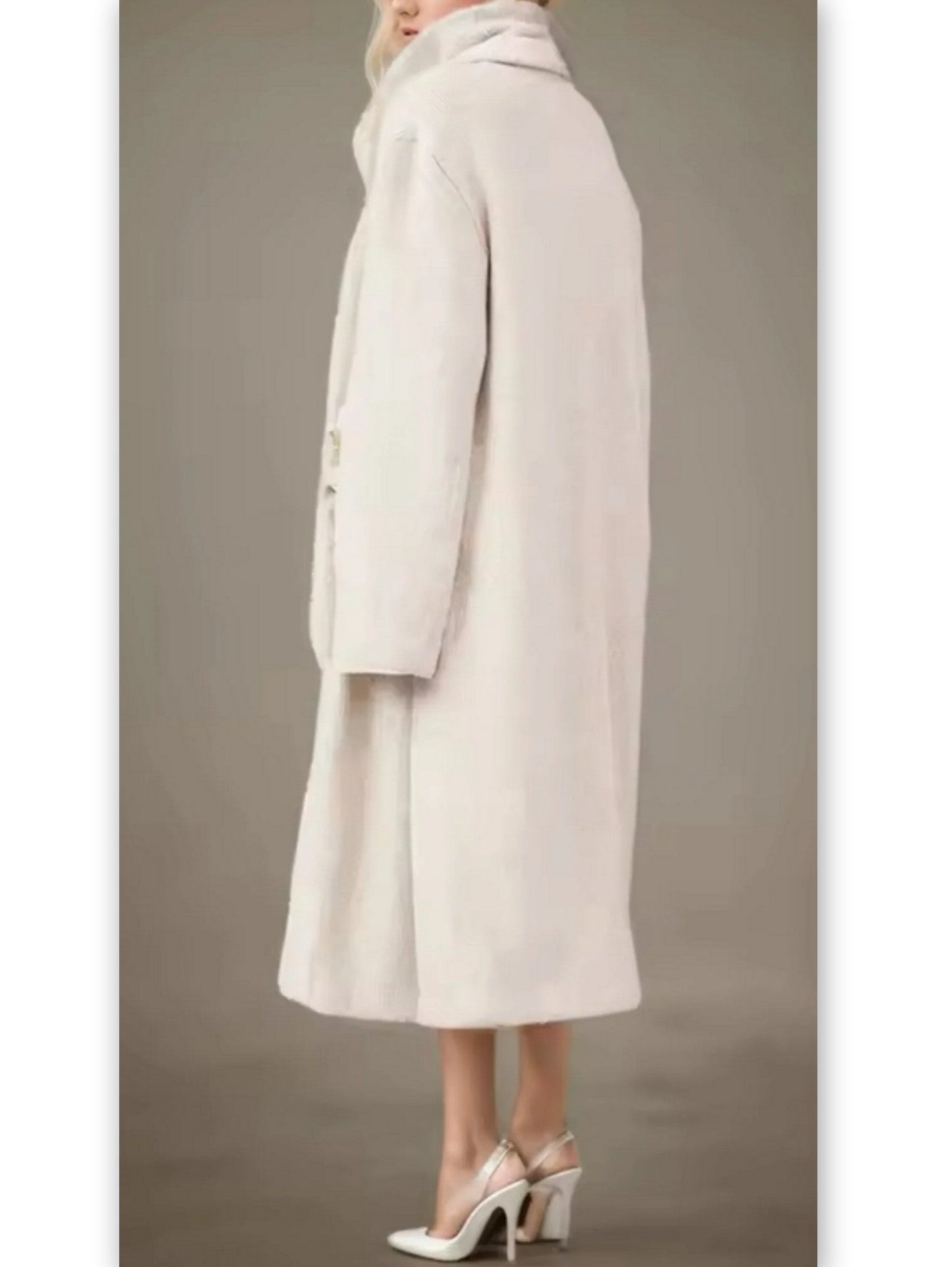 Light-colored textured coat paired with a flower applique skirt and sleeveless turtleneck
