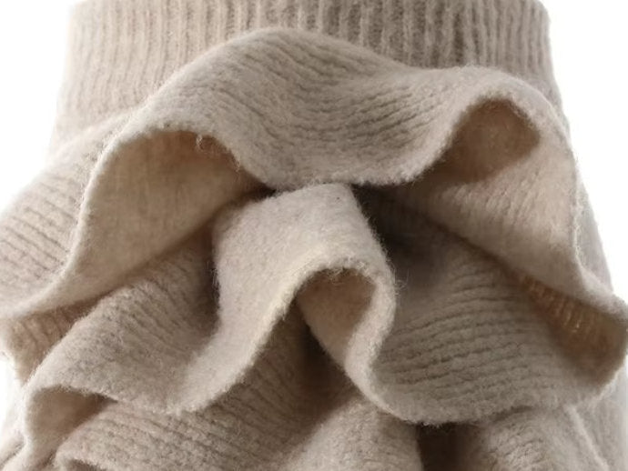 Beige knitwear set featuring a sleeveless turtleneck and flower applique skirt