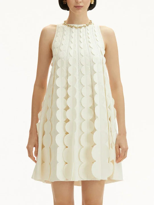 Sleeveless cream circle trapeze knit mini dress with circular embellishments