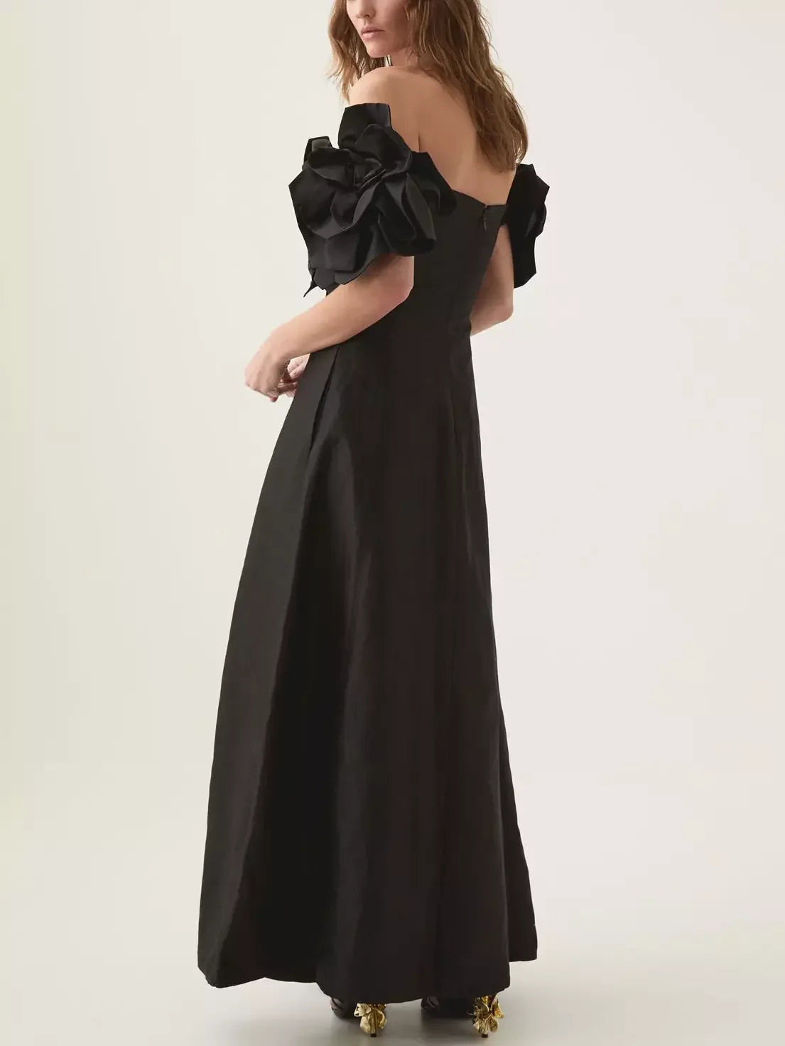 Elegant black off-shoulder gown with floral-appliques sleeve details for a stunning look
