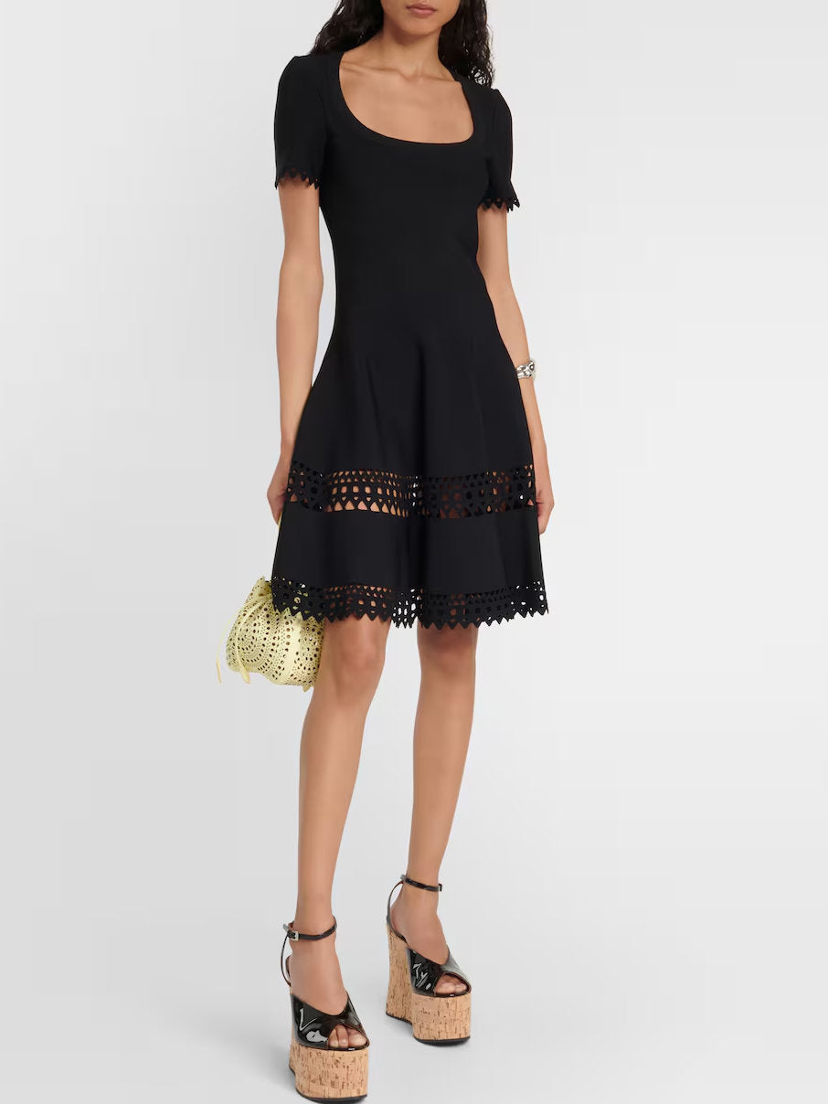 Black stretch knit mini dress with eyelet trim for a stylish A-Line cut