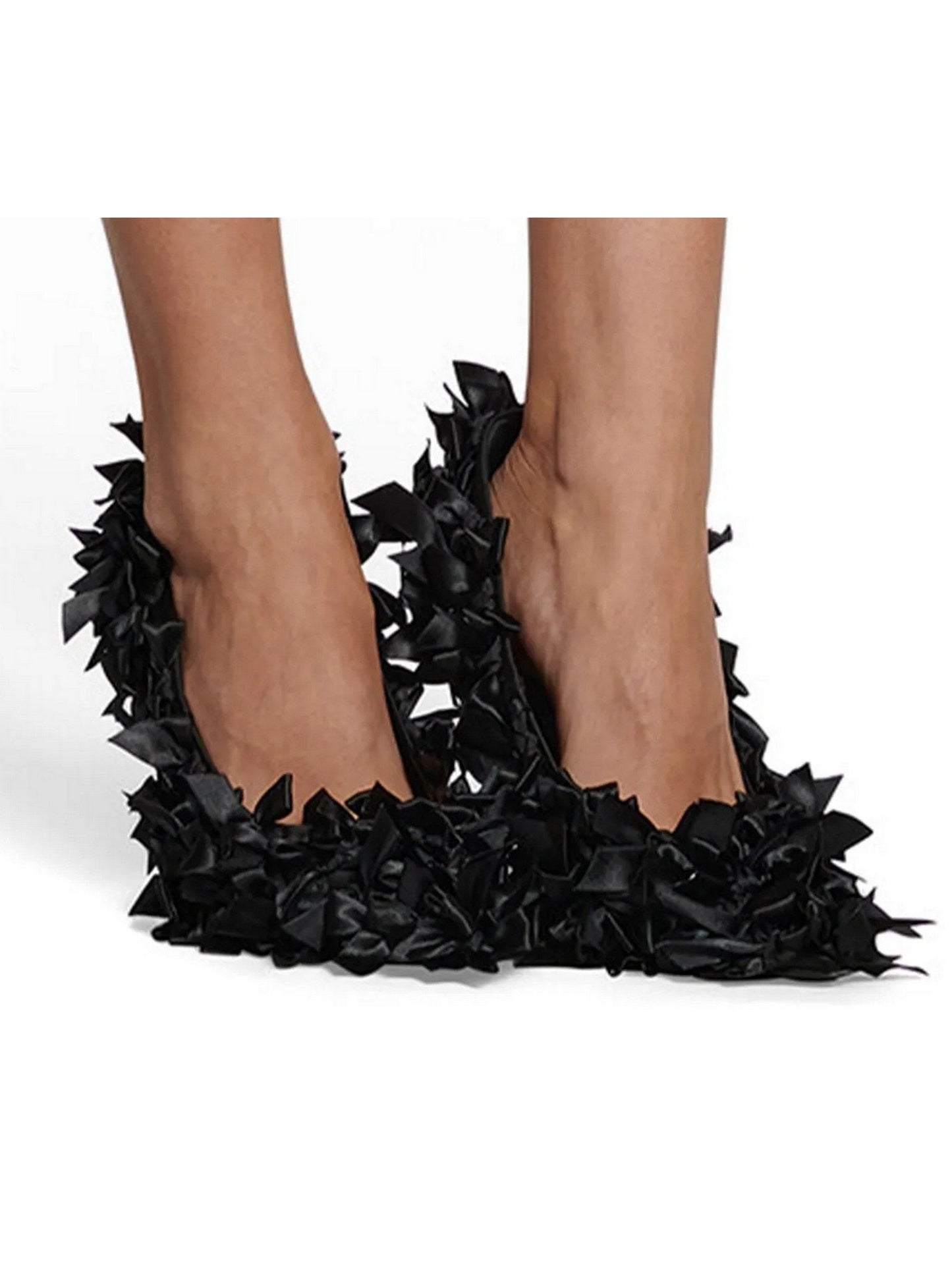 Black bow-embellished pointed toe pumps with fabric ruffles on high-heeled shoe