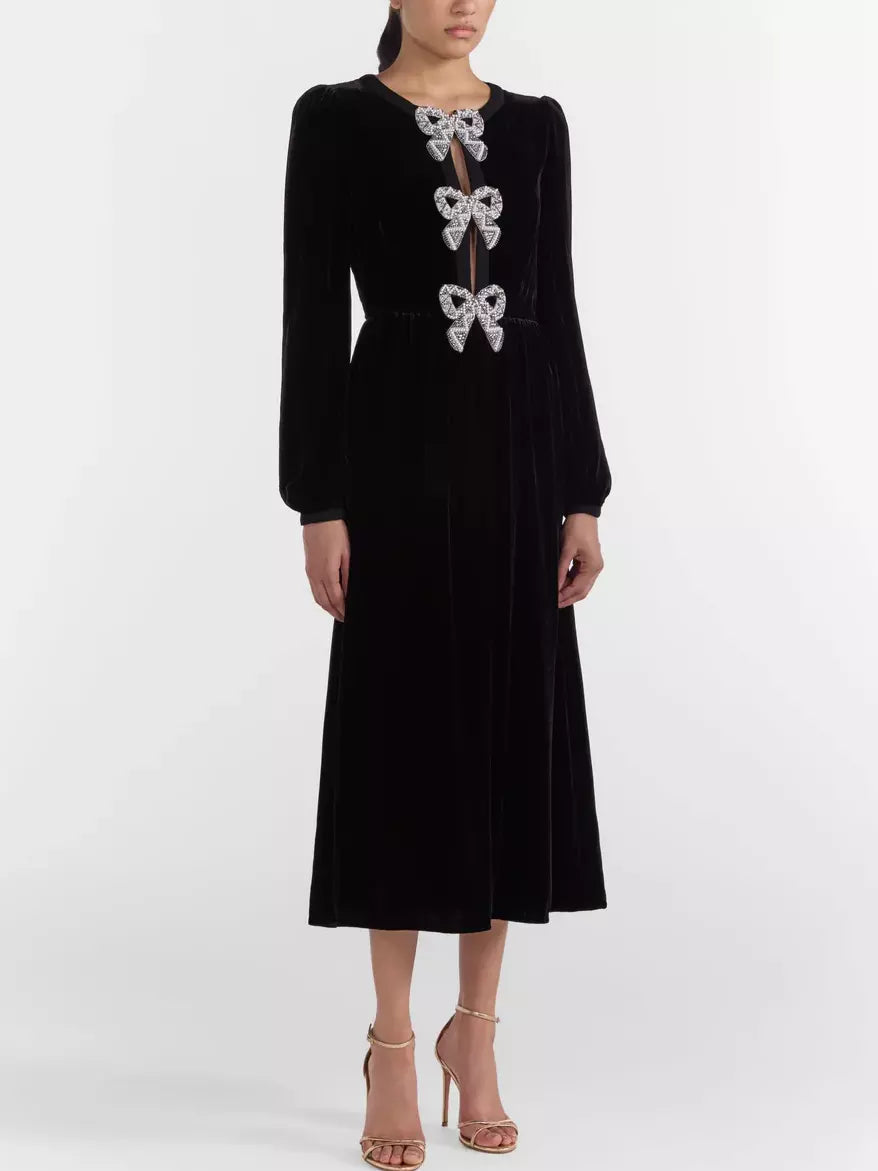 Black Velvet Bow-Embellished Midi Dress with jeweled bows on a chic display