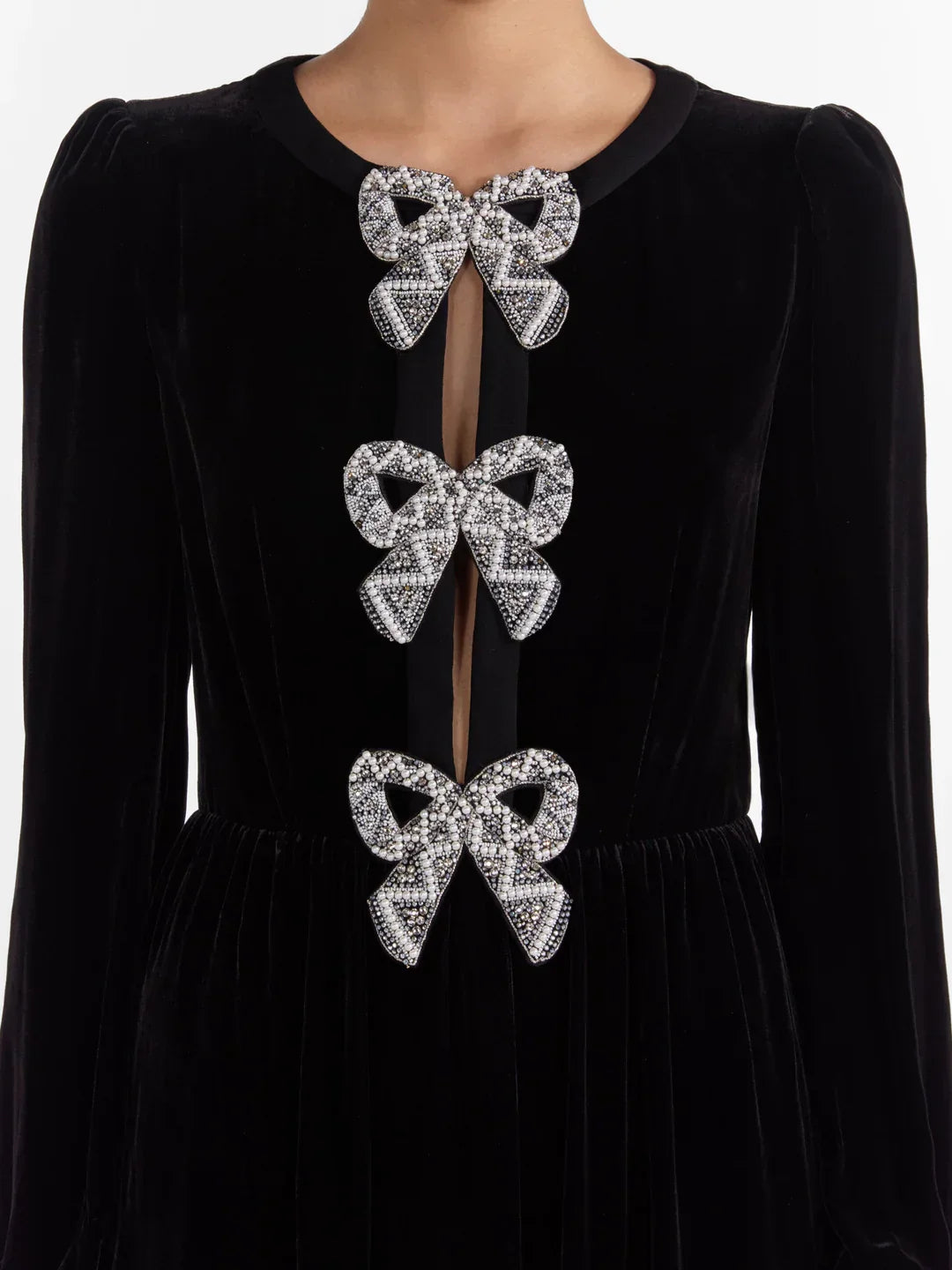 Black velvet bow-embellished midi dress featuring jeweled bows for a chic look