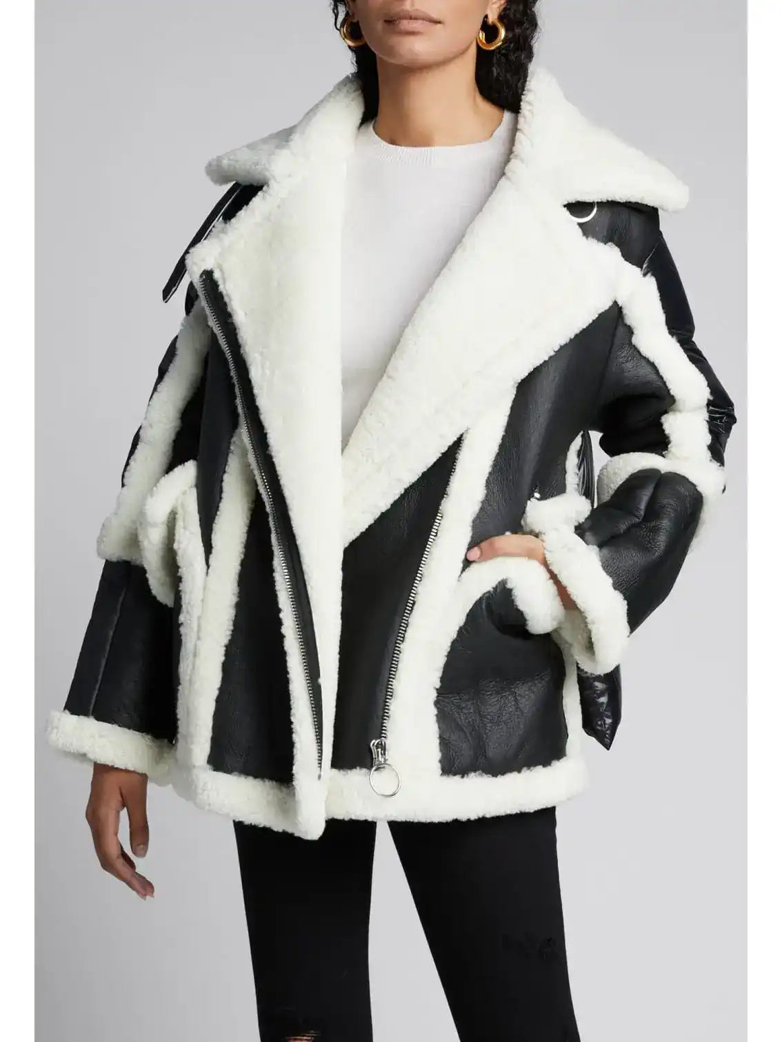Black and white shearling aviator jacket with oversized lapels and asymmetric zipper detailing.