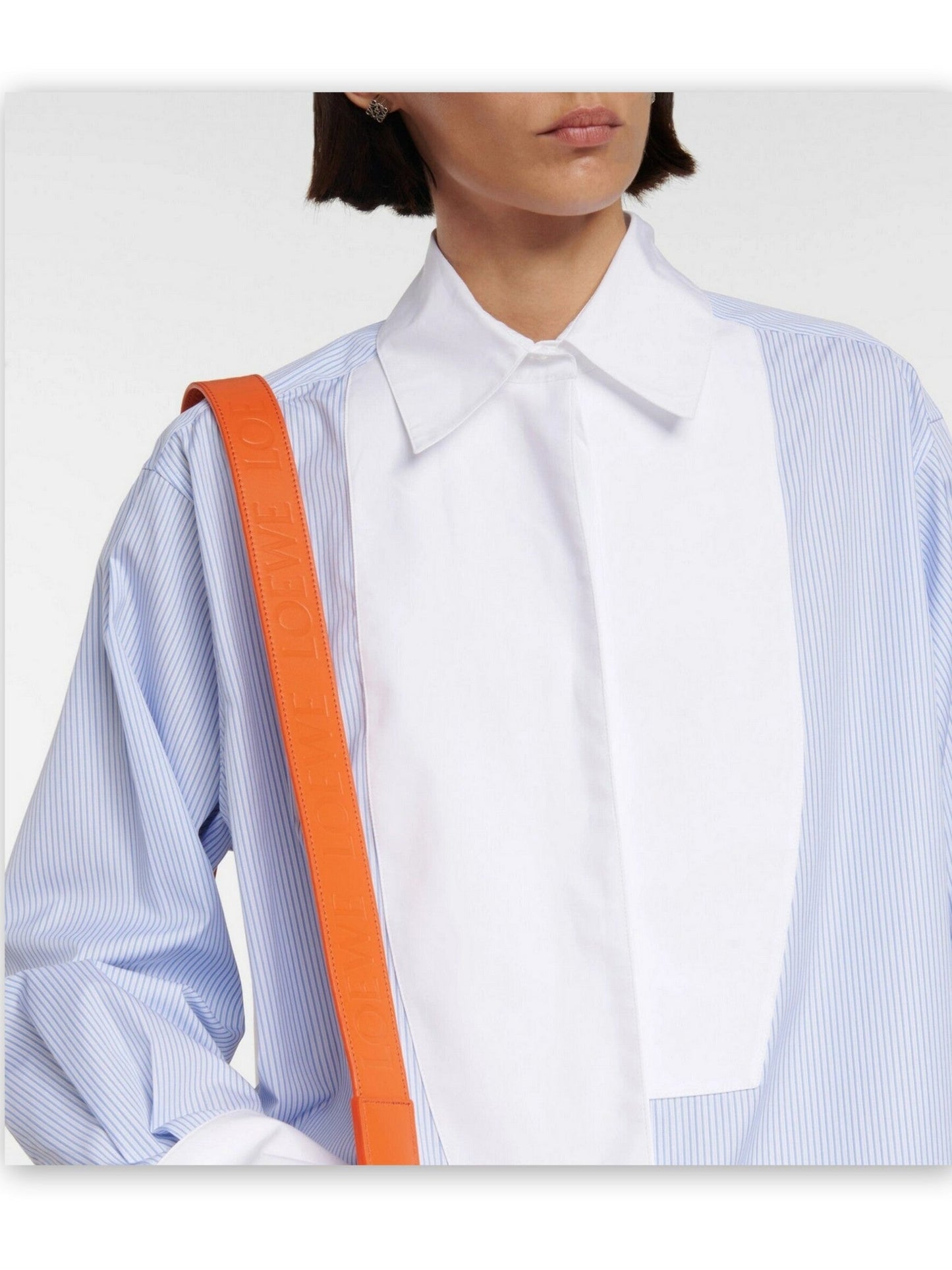 Woman wearing a White Pinstripe Cotton Shirt Dress with an orange handbag and sneakers