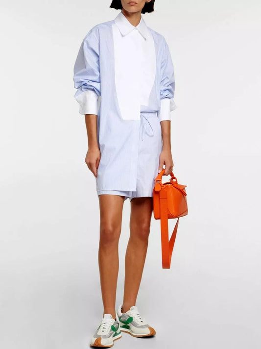 Woman wearing a stylish White Pinstripe Cotton Shirt Dress with orange bag and sneakers