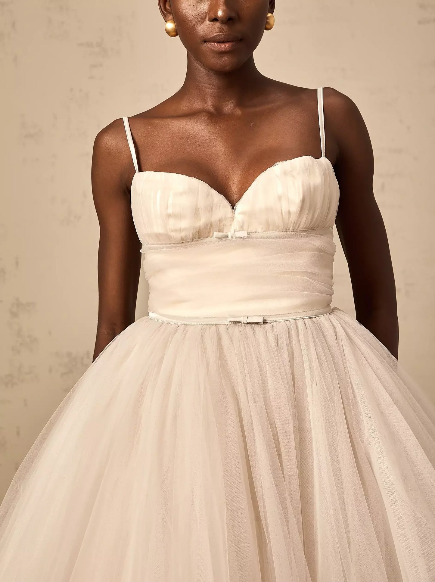 Ivory tulle flared midi dress with bow detail and sleeveless design for elegant fashion