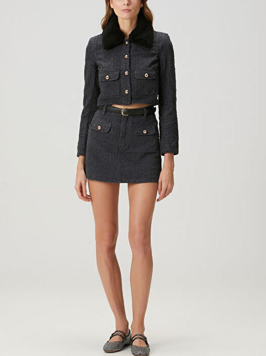 Black tweed skirt set featuring a fur collar and denim boucle-style jacket