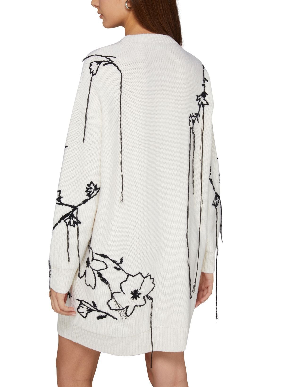 White embroidered knit oversized sweater dress with black floral embroidery detail