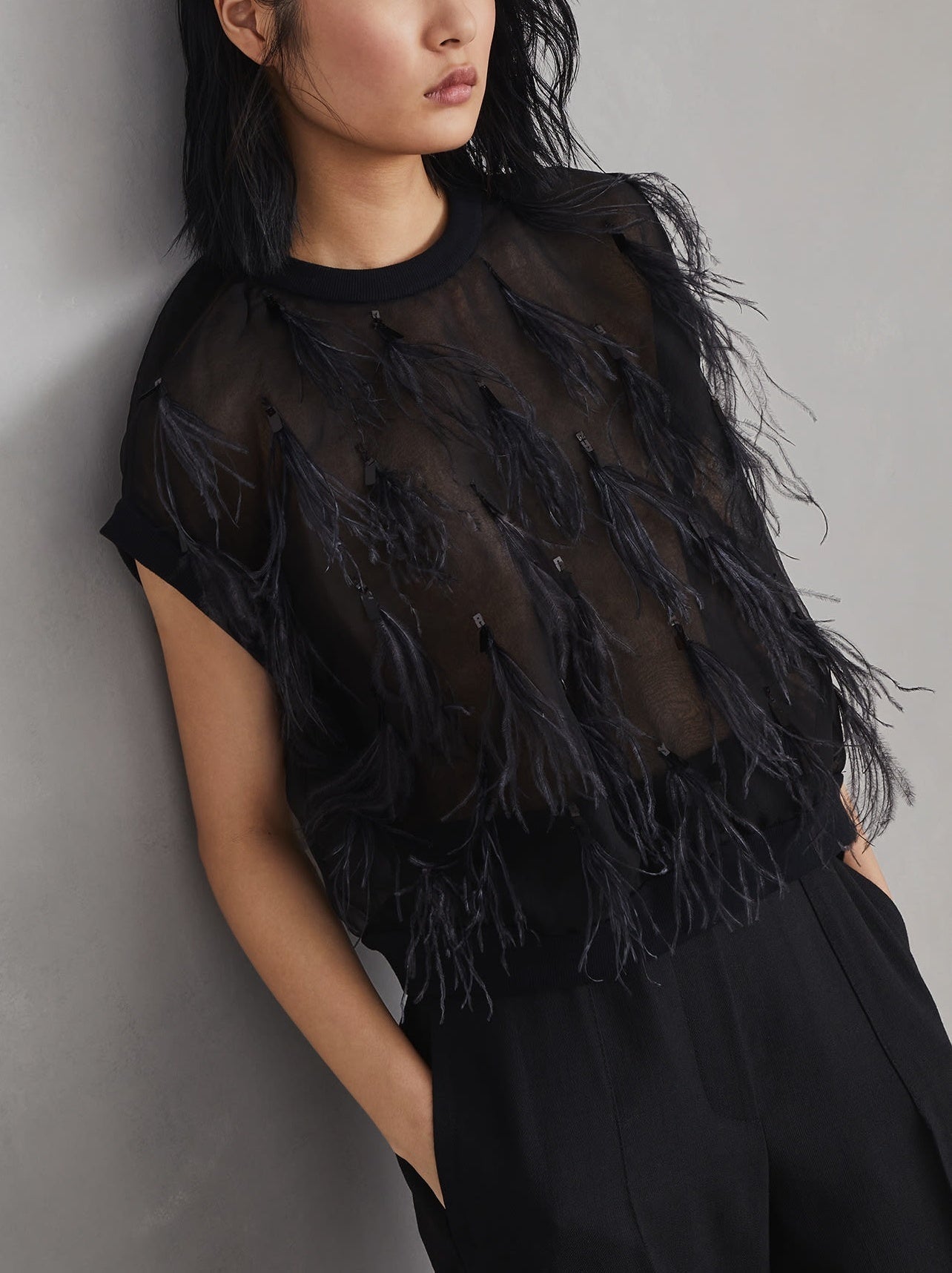 Black Feather-Embellished Knit-Trim Silk Top showcasing elegant design and luxurious texture