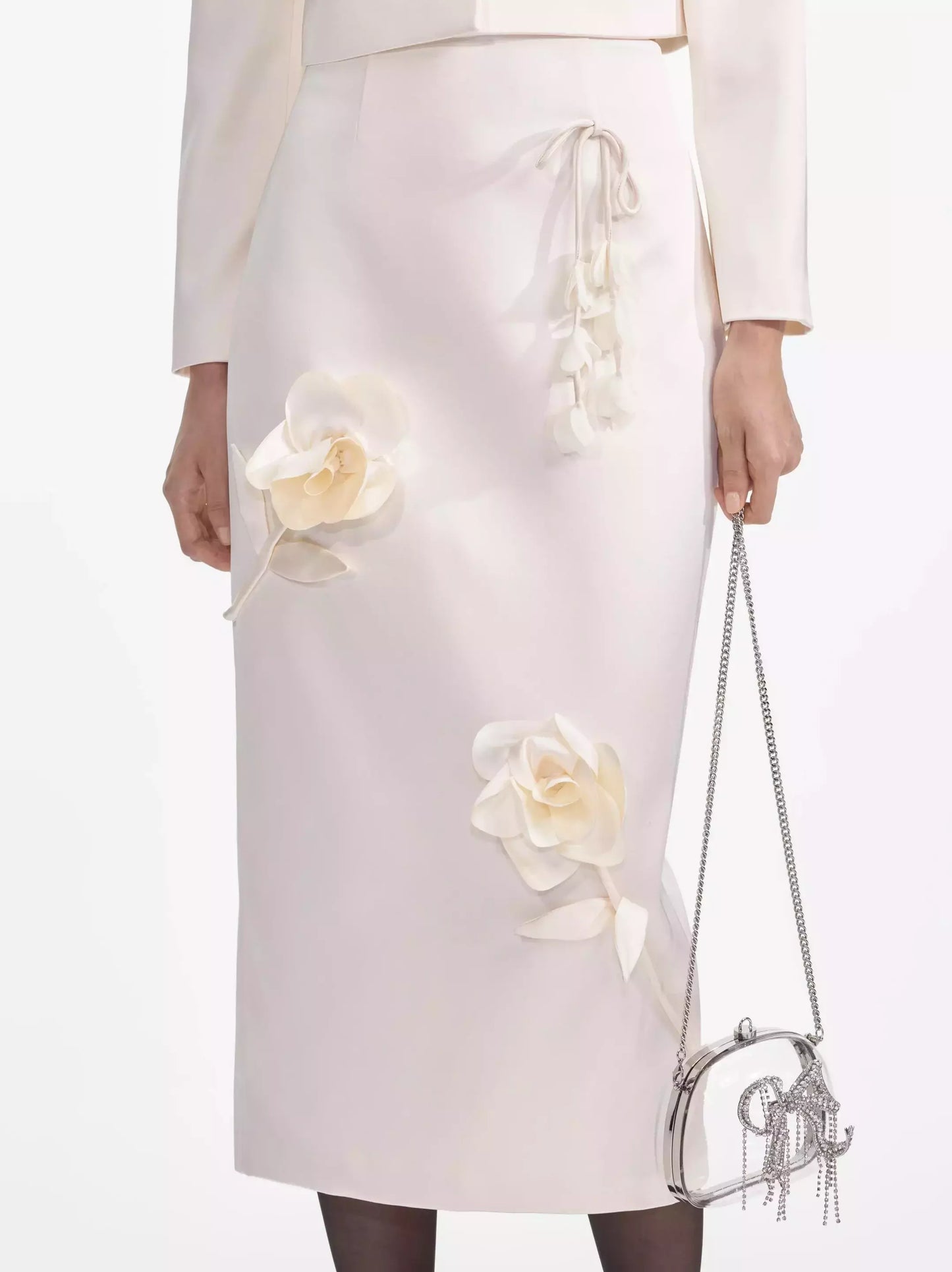 Elegant floral-applique cream midi pencil skirt paired with a chic chain purse
