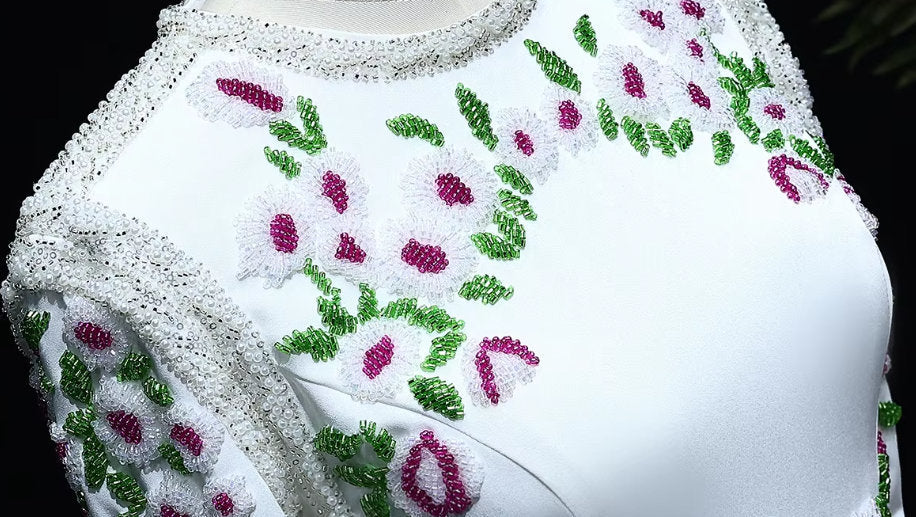 Elegant bead-embellished long white fitted gown with stunning floral embellishments