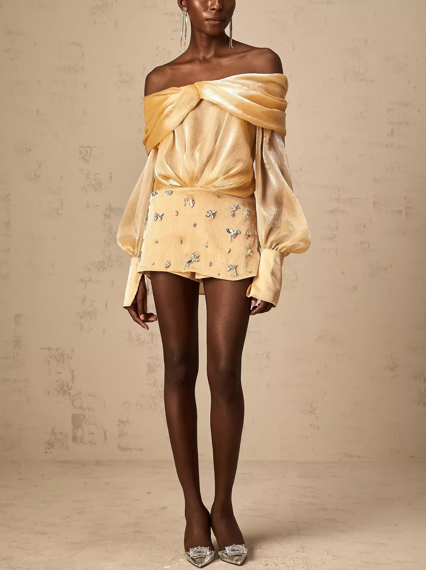 Gold off-shoulder mini dress featuring luxurious satin and rhinestone embellishments