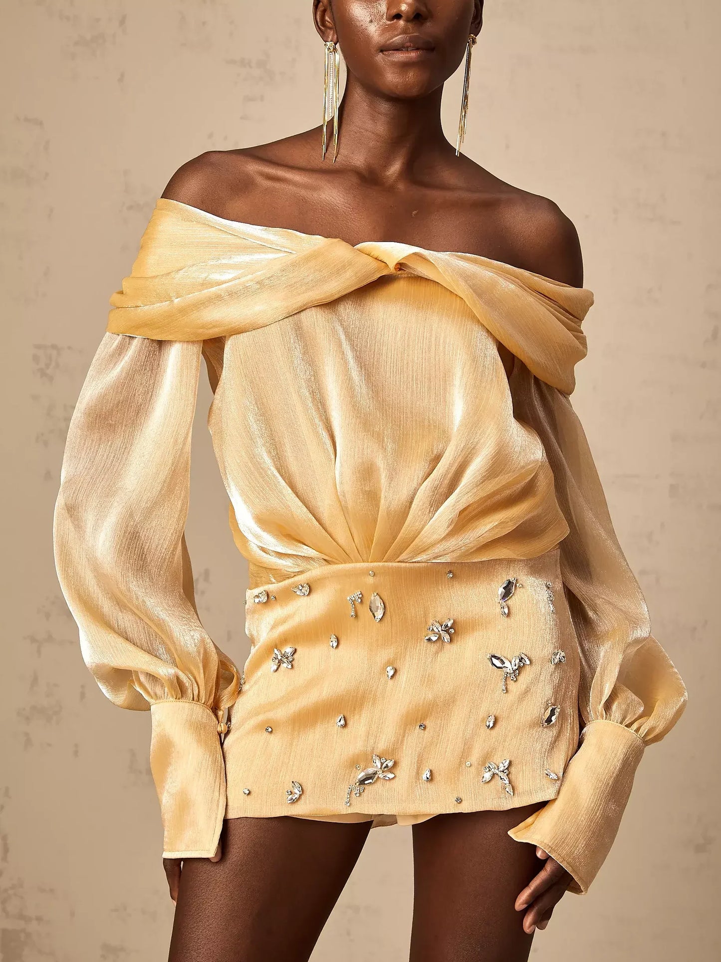 Gold off-shoulder mini dress featuring luxurious satin and stunning rhinestone embellishments