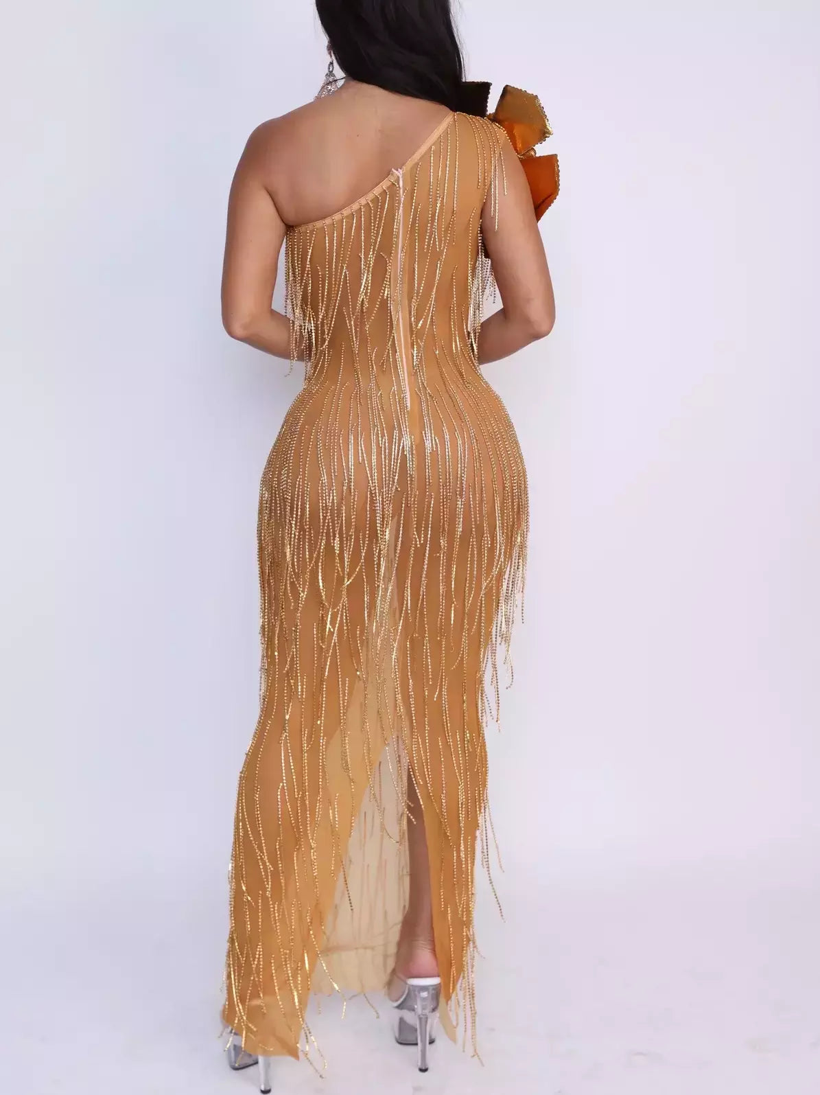 Woman in a Gold Rhinestone-Fringe Dress with large embellished flower appliques