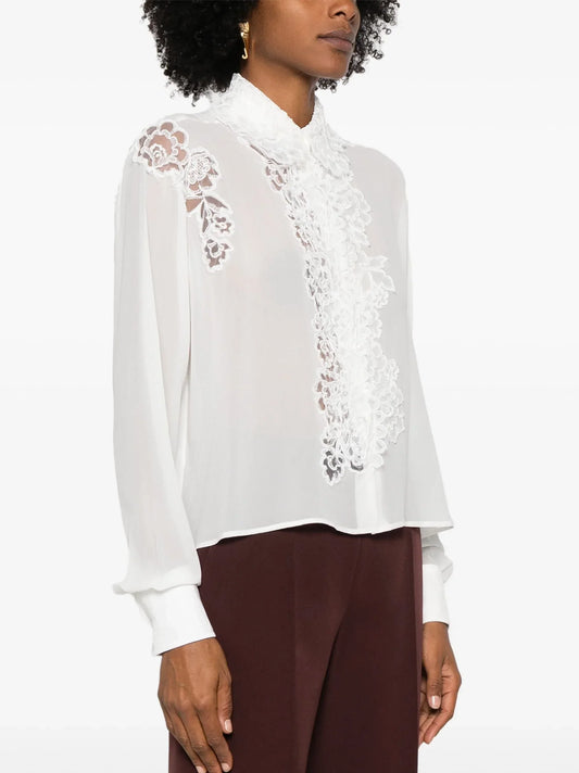 White lace-trimmed blouse showcasing Lace Paneled Silk White Shirt elegance and style