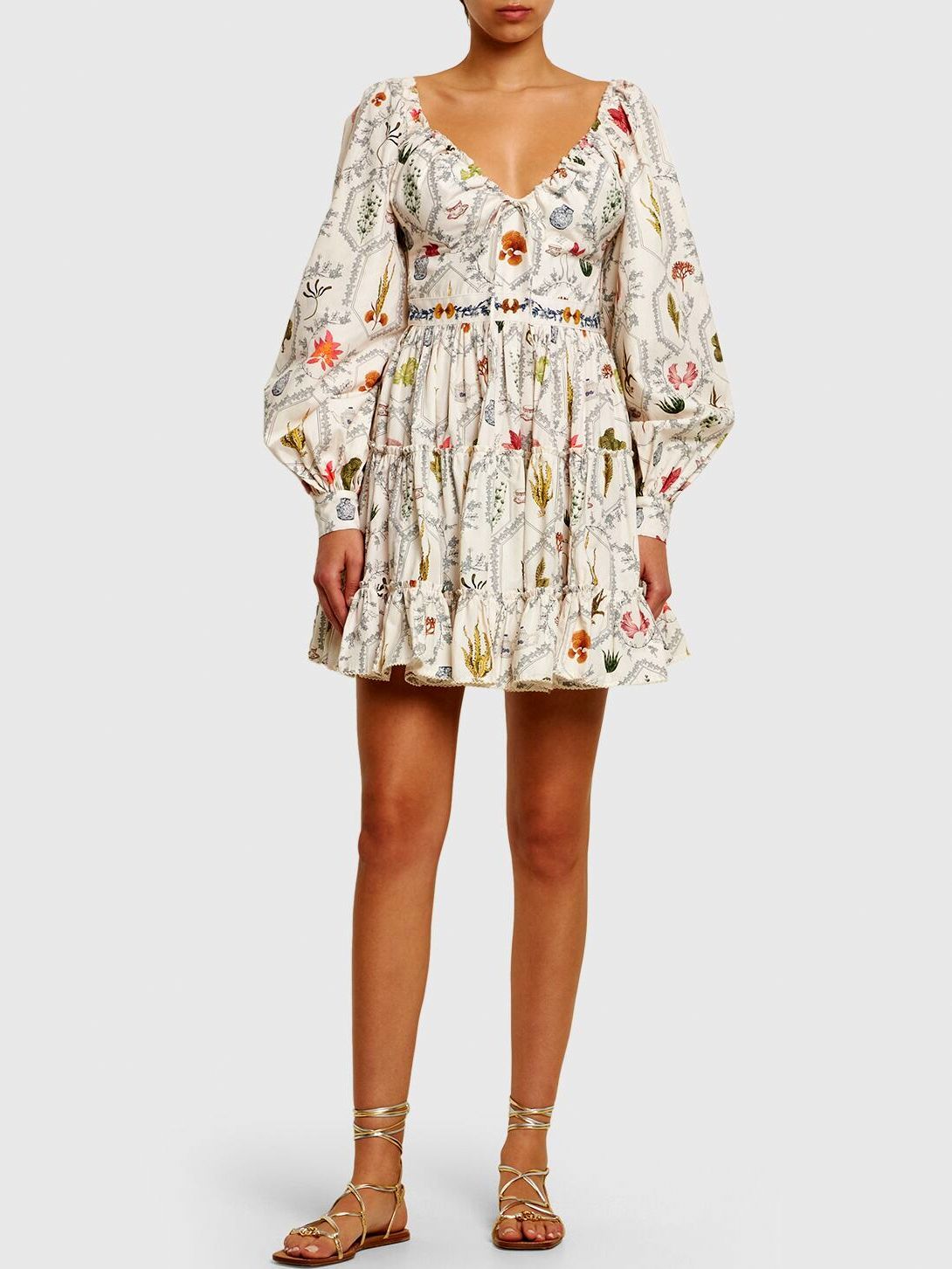Floral print mini dress featuring long puff sleeves and adjustable v-neck drawstring