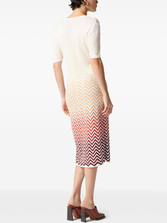 Woman in a Multicolor Zig-Zag Knit Dress showcasing a stylish chevron pattern