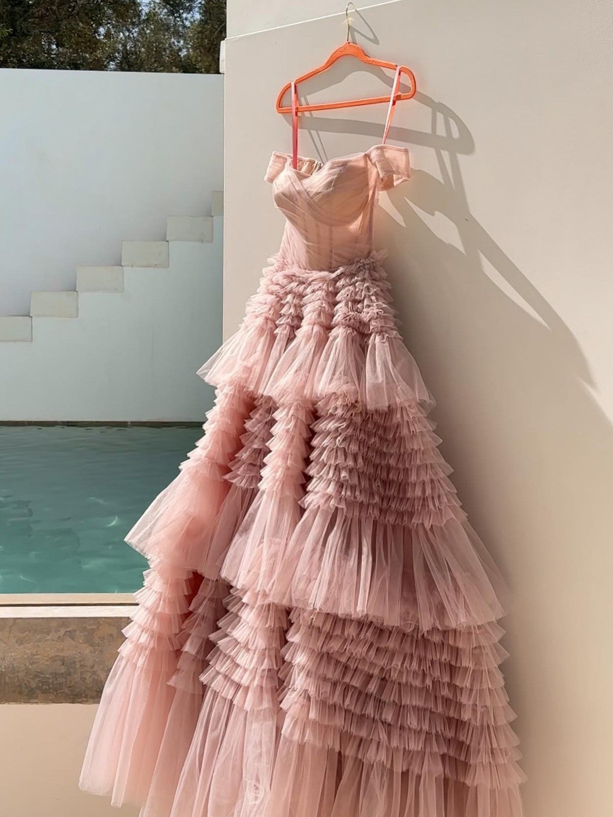 Off-the-shoulder tiered tulle corset gown in pink perfect for special occasions