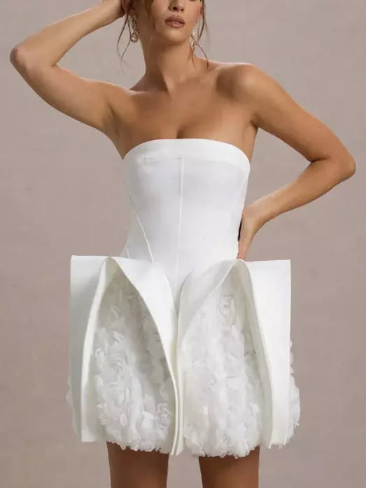 White strapless mini dress featuring sculptured 3D floral design on a dress form
