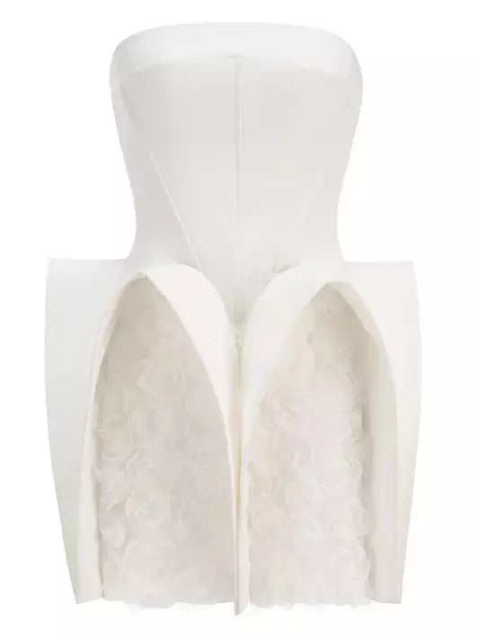 White strapless mini dress featuring sculptured 3D floral designs on a dress form