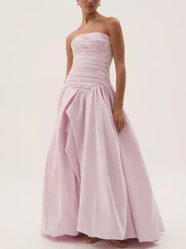 Strapless gathered long pink gown elegantly showcased on a display