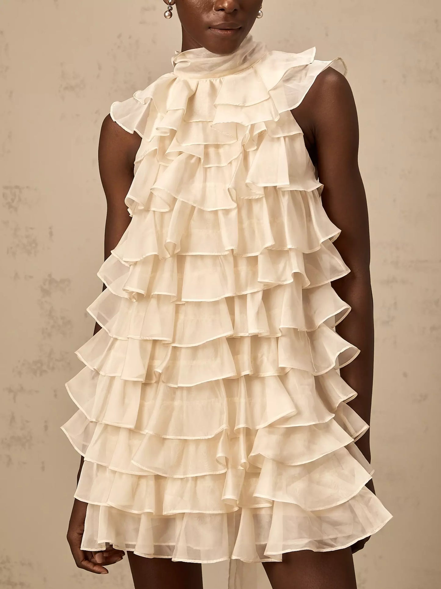 Cream-colored Tie-Neck Tiered Organza Ruffle Mini Dress featuring a large bow