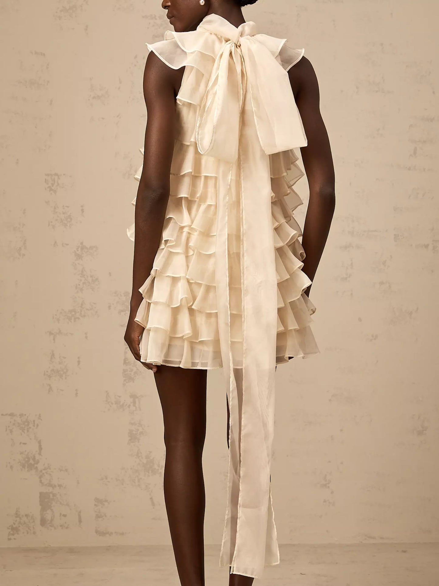 Ruffled cream organza ruffle mini dress featuring a tie-neck in light beige