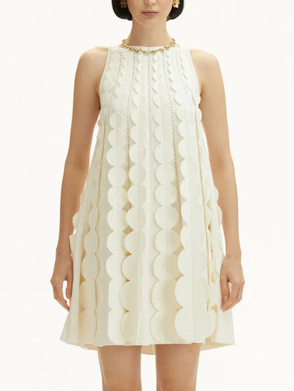 Sleeveless cream circle trapeze knit mini dress with circular embellishments