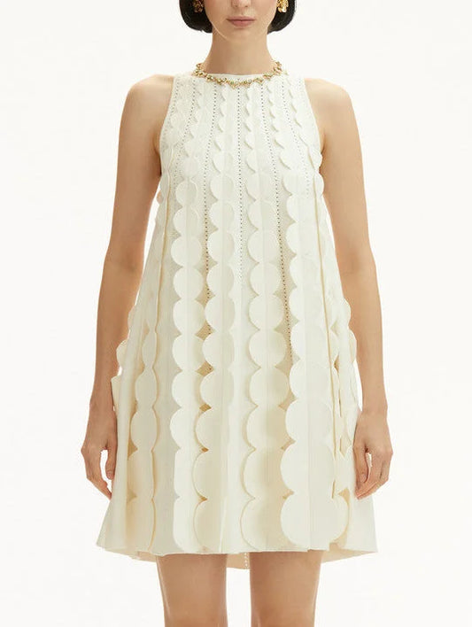 Sleeveless cream circle trapeze knit mini dress with circular embellishments