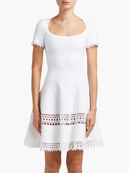 White eyelet-trimmed A-Line Cut-Out Stretch Knit Mini Dress displayed elegantly