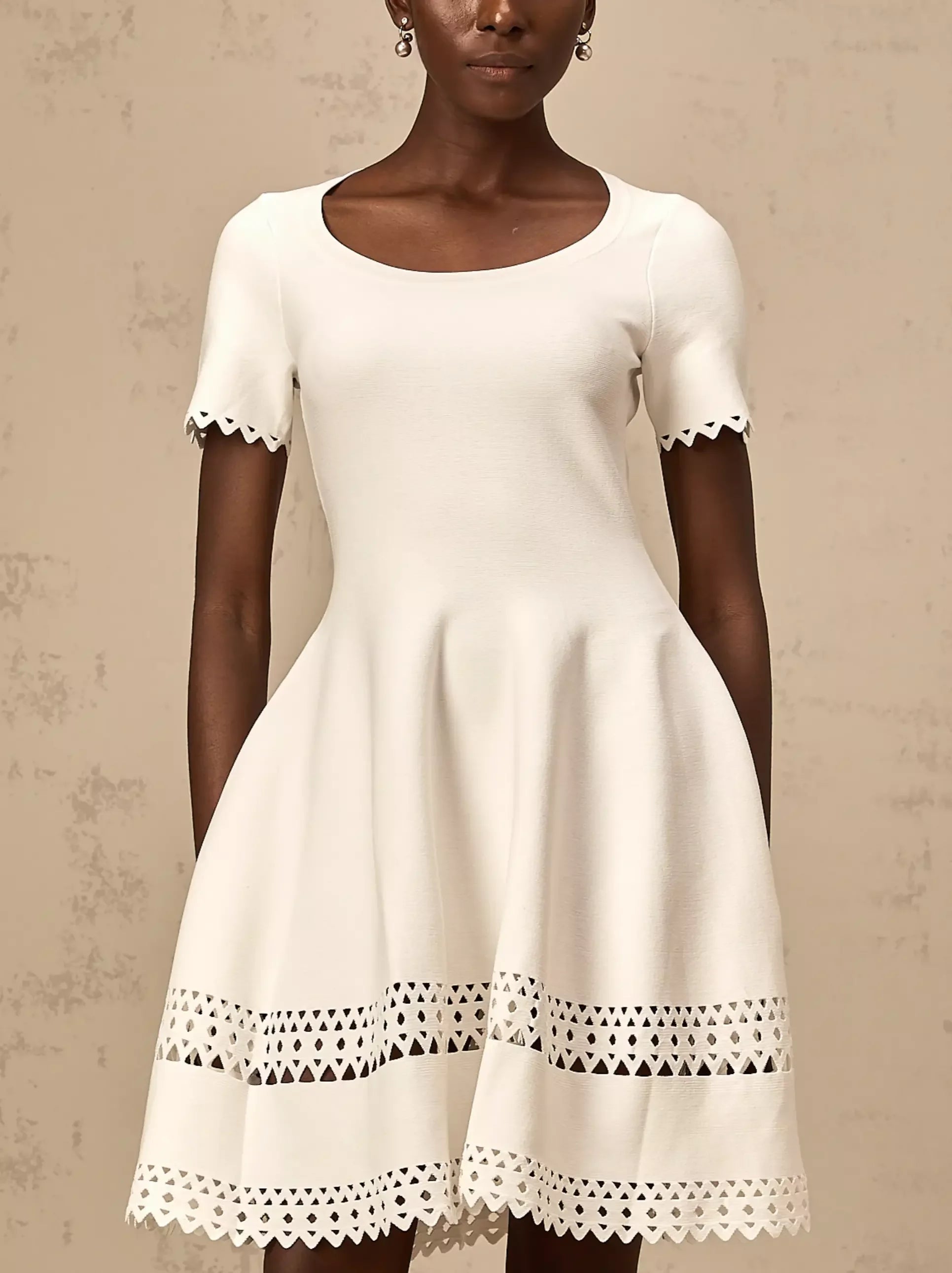 White A-Line Cut-Out Stretch Knit Mini Dress with scalloped trim for a chic look