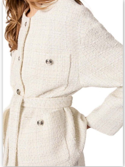 Cream-colored tweed jacket with belt from Branna Couture in luxury women’s apparel