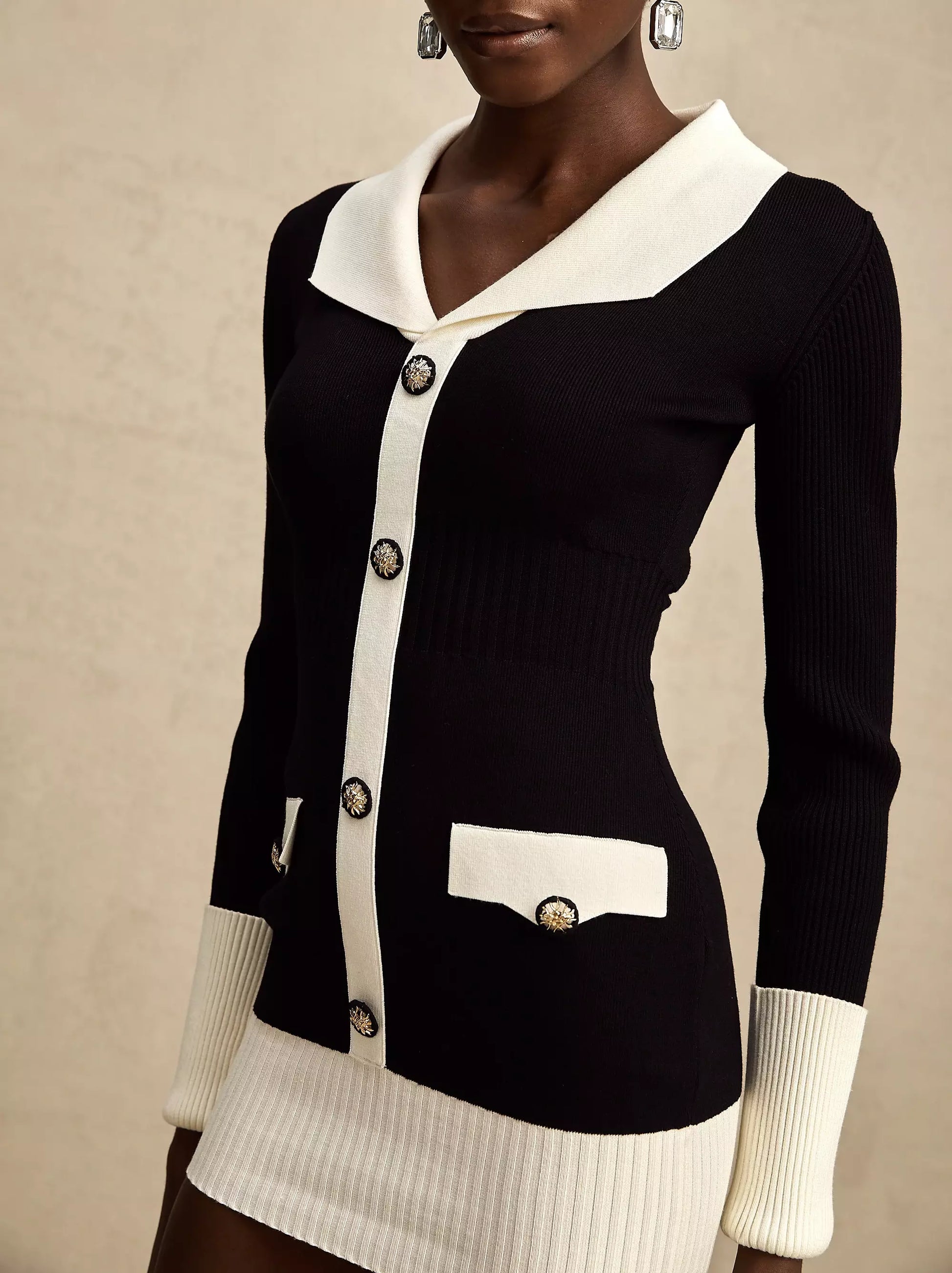 Bicolor Ribbed Knit Mini Sweater Dress in black and white showcasing stylish design