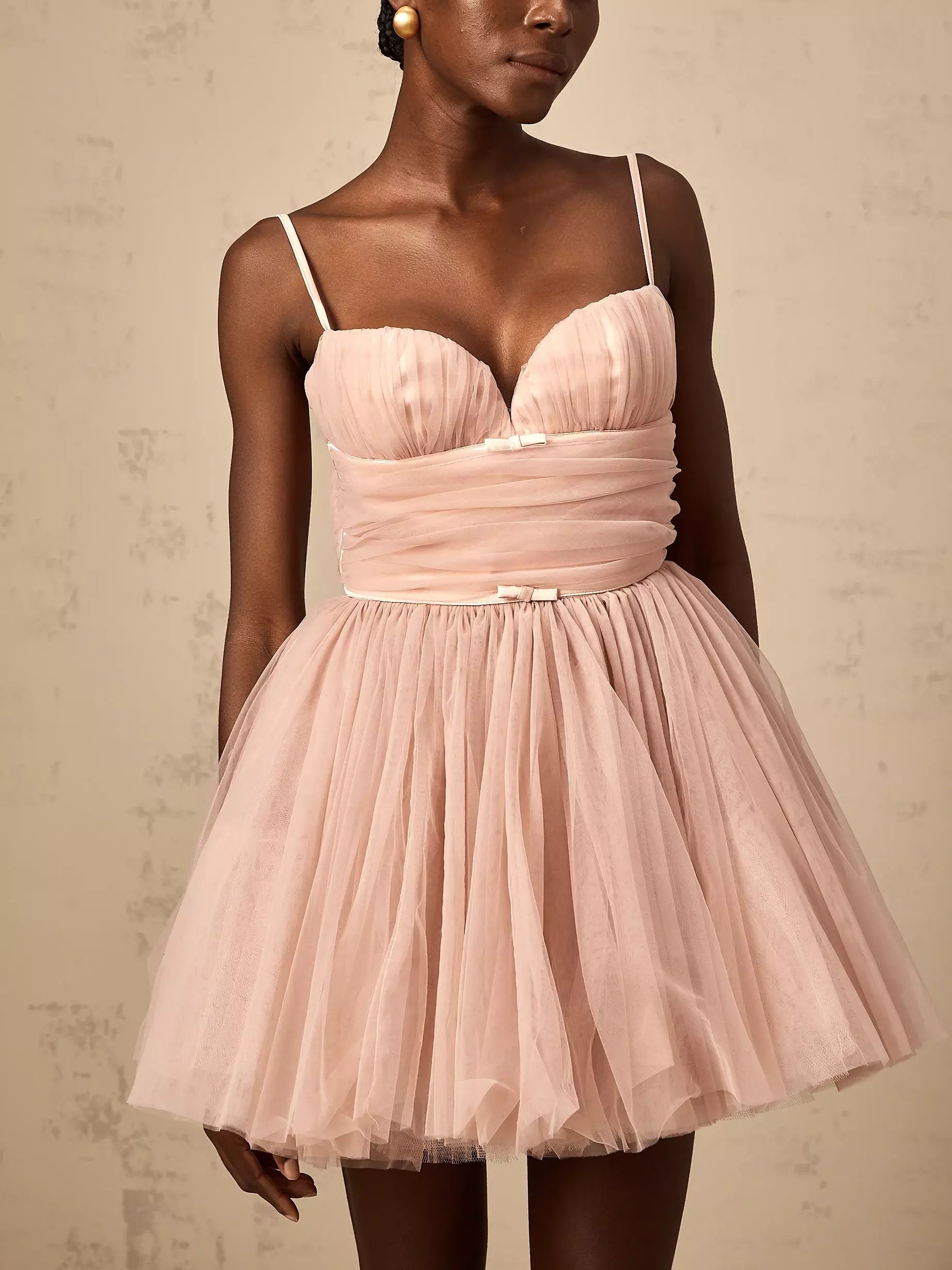 Pink tulle flared mini dress with bow-detail, perfect for stylish summer occasions