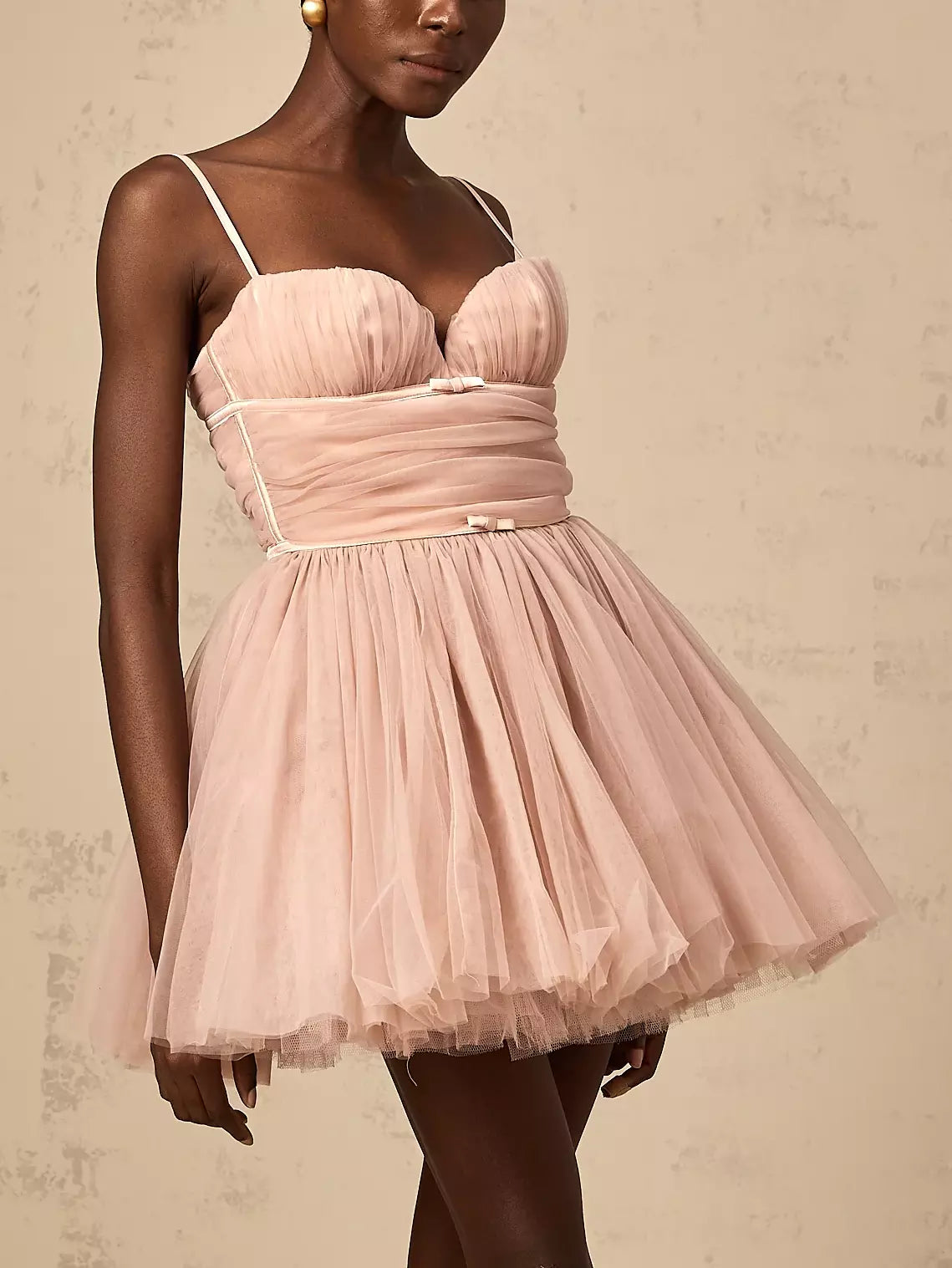 Pink tulle flared mini dress featuring a stylish bow-detail sleeveless design