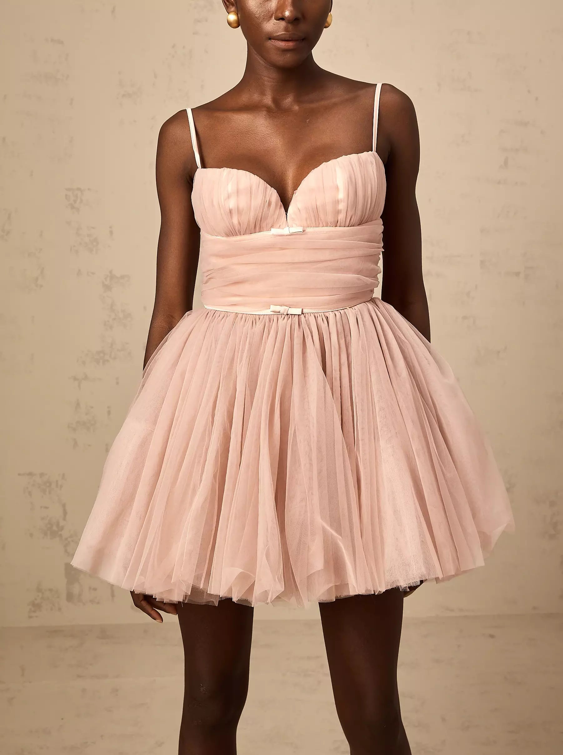 Bow-Detail Sleeveless Tulle Flared Mini Dress in pink showcasing its elegant design