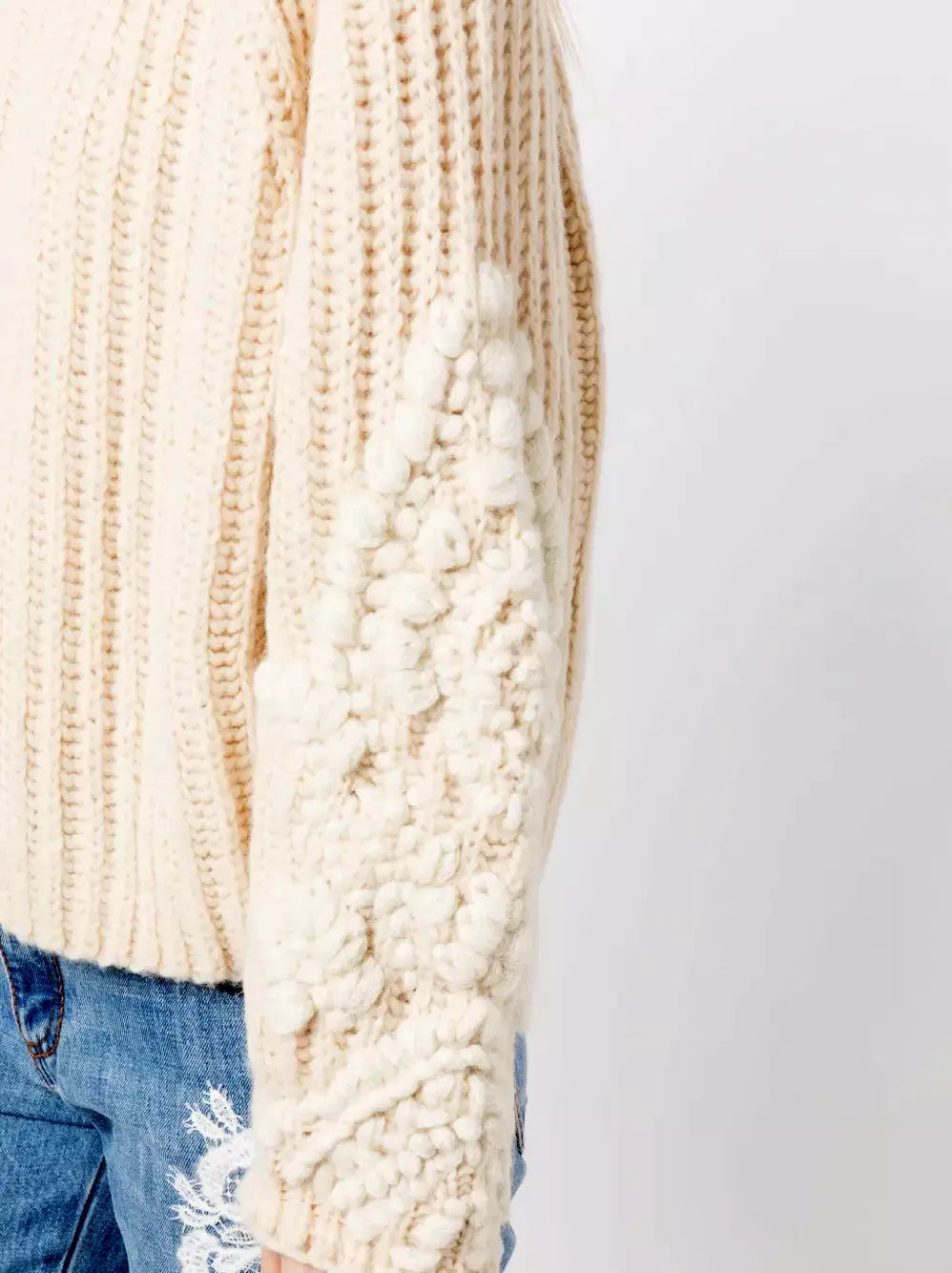 Cream-colored Chunky Embroidered Knit Turtleneck Sweater with textured sleeves