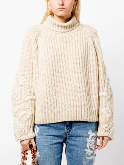 Cream-colored chunky embroidered knit turtleneck sweater with floral sleeves