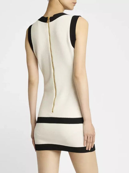 Sleeveless cream knit mini dress with black trim and gold zipper detail