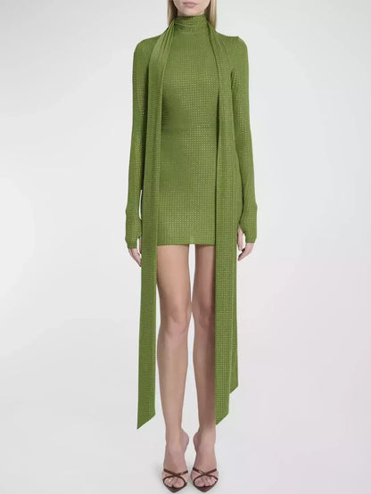 Green knit mini dress with attached scarf, featuring a crystal-embellished long sleeve scarf
