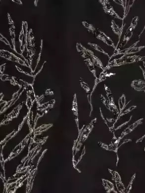 Silver leaf pattern on black fabric of an embroidered black cotton linen front-slit skirt