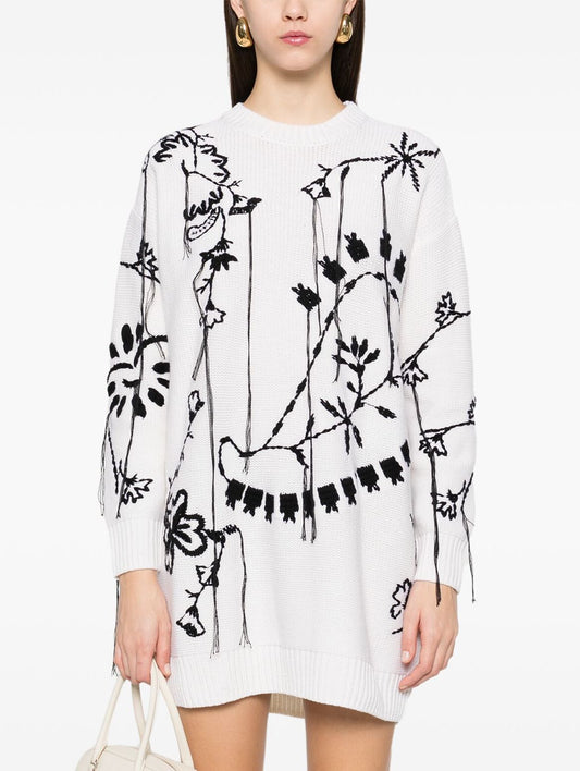 White sweater dress with black floral design, perfect as an embroidered knit oversized piece