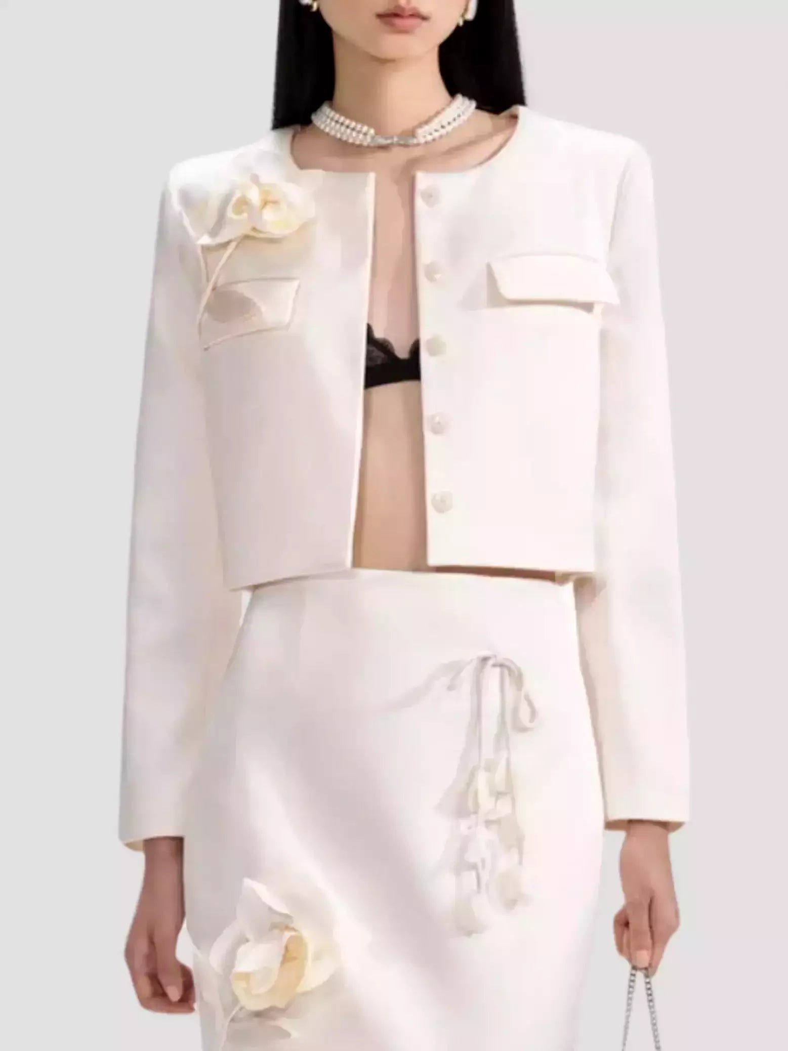 Elegant white skirt suit featuring a Floral-Applique Cream Jacket with Concealed Button Placket