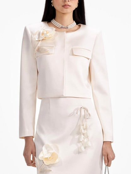 Elegant cream-colored skirt suit featuring a floral-applique cream jacket with concealed button placket