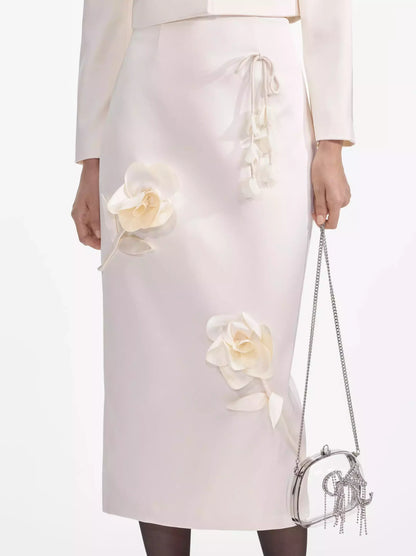 Elegant floral-applique cream midi pencil skirt paired with a chic chain purse