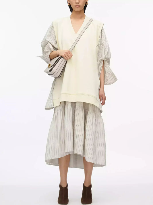 Woman’s layered look featuring Oversized Vest Sweatshirt with Striped Combo Dress