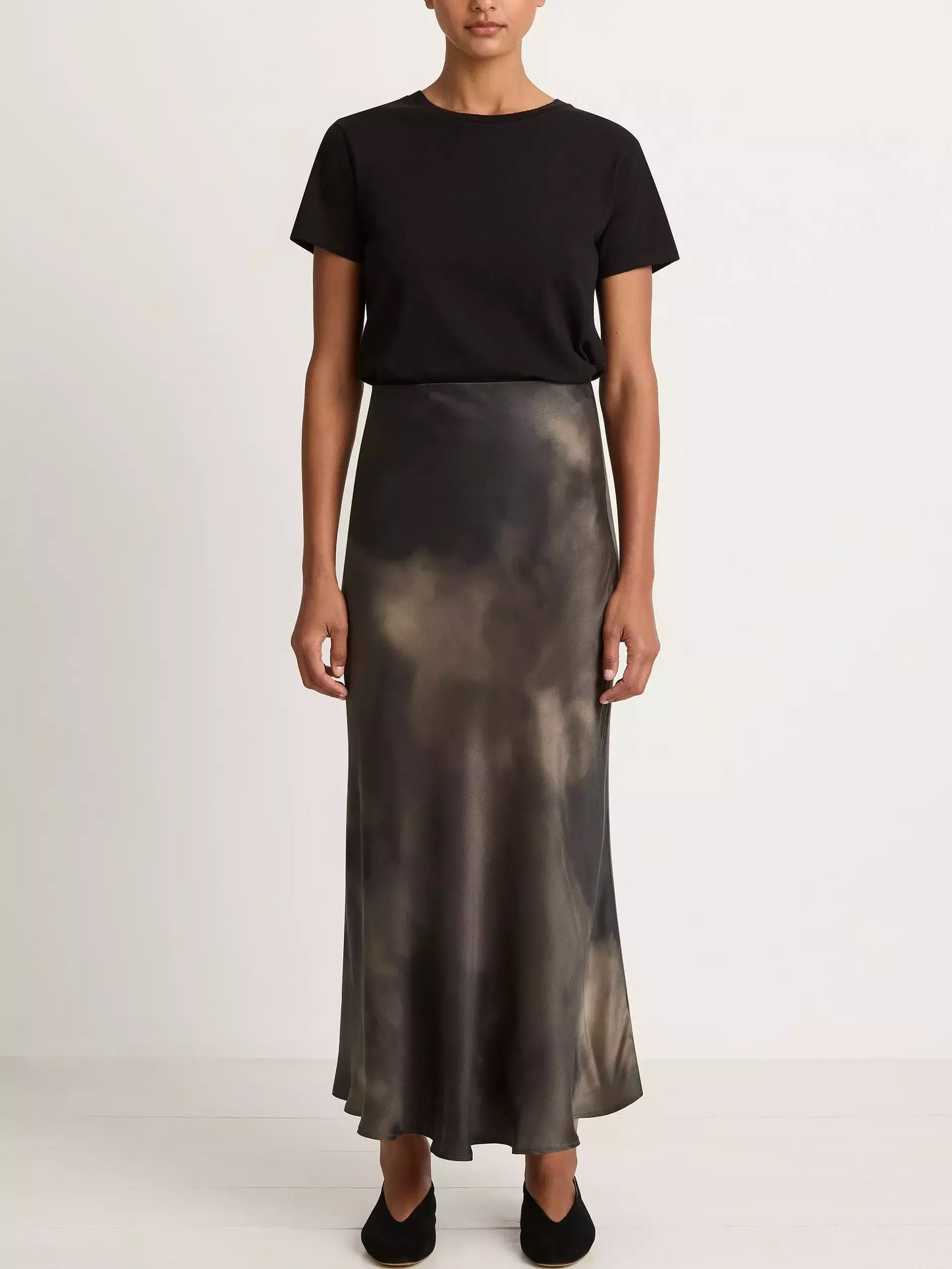 Woman in a black t-shirt with a Silk Sand-Washed Long Skirt in a tie-dye design